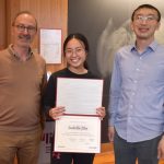 Michel Goemans and Yufei Zhao flank Isabella Zhu, who is holding her certificate.