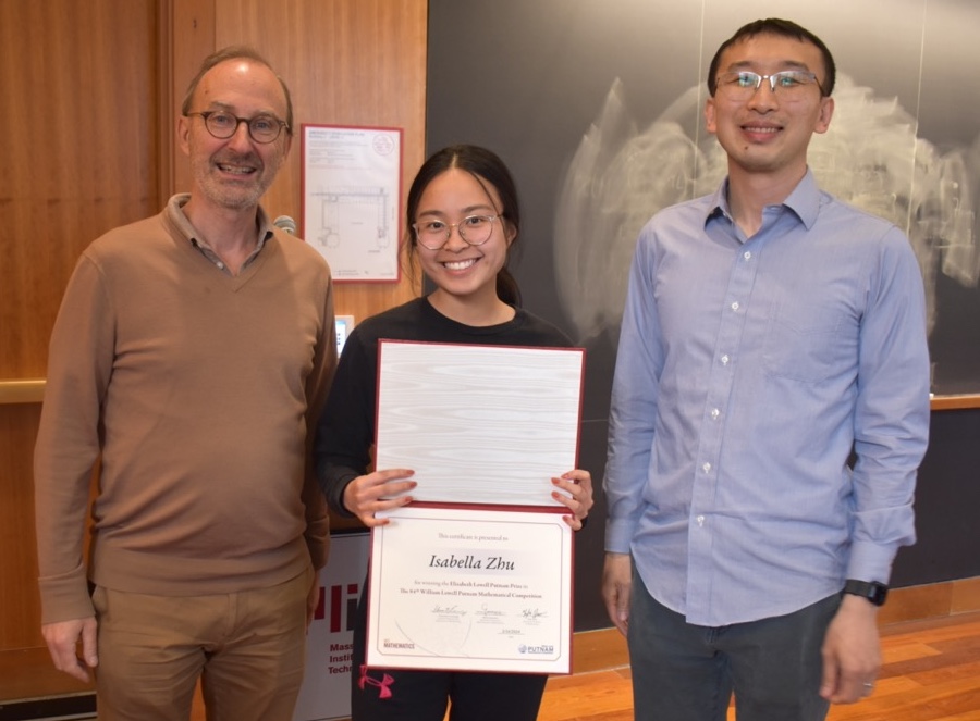 Michel Goemans and Yufei Zhao flank Isabella Zhu, who is holding her certificate.